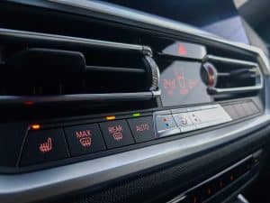 BMW dashboard climate control panel with AC button